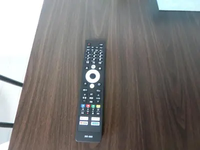 a remote control sitting on top of a wooden table at \u6e0b\u8c37\u533a\u4ee3\u3005\u6728402 in Tokyo