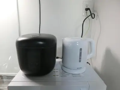 a black appliance sitting on a counter next to a cup at \u6e0b\u8c37\u533a\u4ee3\u3005\u6728402 in Tokyo