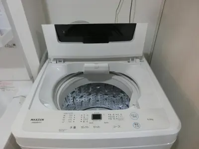 a washing machine with its door open in a bathroom at \u6e0b\u8c37\u533a\u4ee3\u3005\u6728402 in Tokyo
