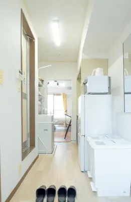 a room with a white refrigerator and a hallway at UPHouse 2C Gotokuji in Tokyo
