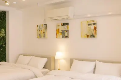 two beds sitting next to each other in a bedroom at 8min walk from Shibuya Sta in Tokyo