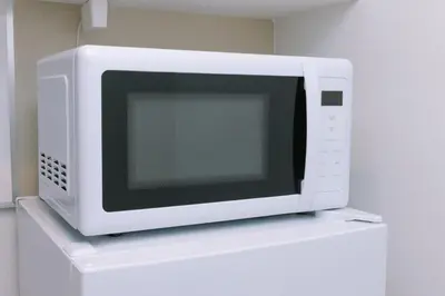 a microwave oven sitting on top of a shelf at 8min walk from Shibuya Sta in Tokyo