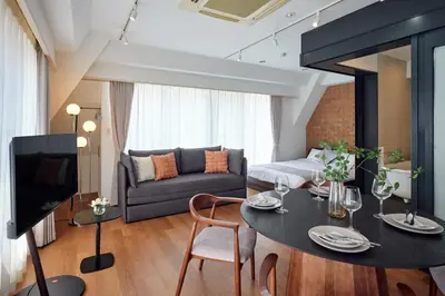 a living room with a table and a couch at 5min to Shibakoen 49square meters Cozy Stay Near Tokyo Tower in Tokyo