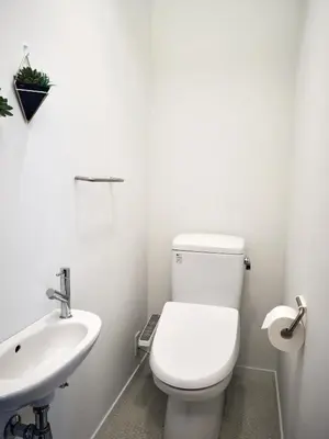 a white bathroom with a toilet and a sink at 5min to Shibakoen 49square meters Cozy Stay Near Tokyo Tower in Tokyo