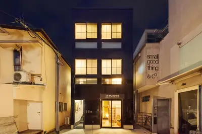 a building with a door in a street at night at \u30de\u30a4\u30b0\u30ec petit \u6e0b\u8c37\u539f\u5bbf in Tokyo