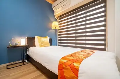 a bedroom with a large bed and a window at My Sumida Home 2A in Tokyo