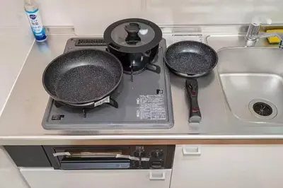 a kitchen counter with two pans and a sink at My Sumida Home 2A in Tokyo