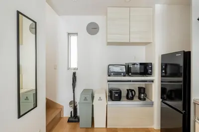 a kitchen with white walls and a counter with appliances at Renovation Open! Tokyo Sumida Tachibana Residence, 5minutes on foot from the station in Tokyo