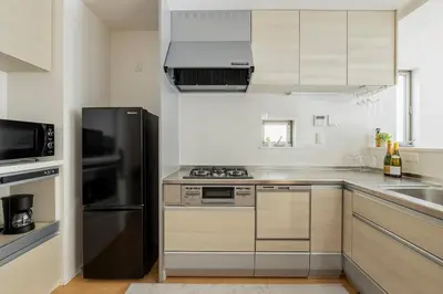 a kitchen with a black refrigerator and a sink at Renovation Open! Tokyo Sumida Tachibana Residence, 5minutes on foot from the station in Tokyo