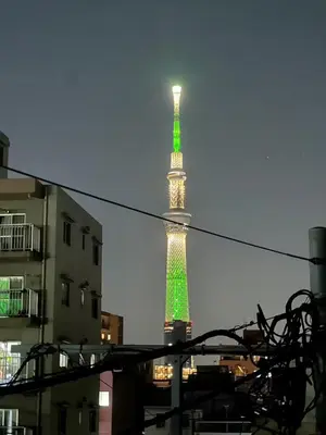 a tall tower with a green and white at Renovation Open! Tokyo Sumida Tachibana Residence, 5minutes on foot from the station in Tokyo