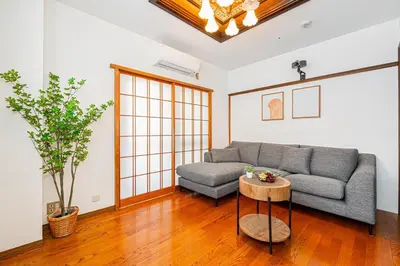a living room with a couch and a table at Mori House \u5fd7\u83022-3F in Tokyo