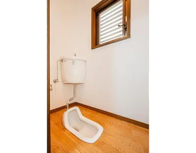 a bathroom with a toilet in the corner of a room at Mori House \u5fd7\u83022-3F in Tokyo