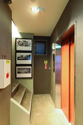 a hallway with a staircase and a door in a room at the Moto Hotel Ueno in Tokyo