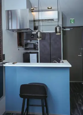 a kitchen with a bar with a black stool at the Moto Hotel Ueno in Tokyo