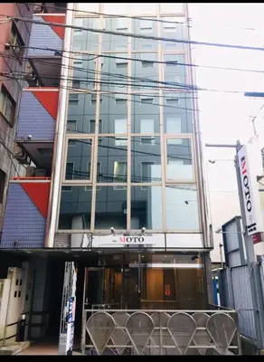 a building with a lot of windows on it at the Moto Hotel Shinjuku in Tokyo