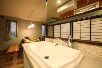 a bathroom with a large white sink in a room at the Moto Hotel Shinjuku in Tokyo