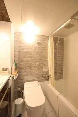 a bathroom with a toilet and a sink and a tub at the Moto Hotel Shinjuku in Tokyo