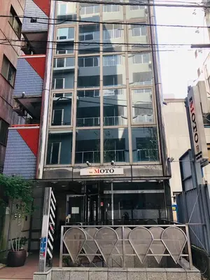 a building with a sign on the front of it at the Moto Hotel Shinjuku in Tokyo