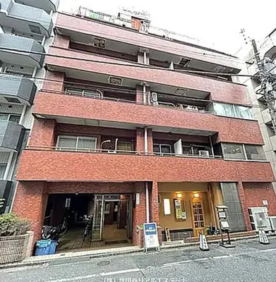 a red brick building with a balcony in front of it at HAMAMATSUCHO Mansion #Minato-Ku in Tokyo
