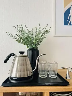 a tea kettle and two glasses on a table at HAMAMATSUCHO Mansion #Minato-Ku in Tokyo