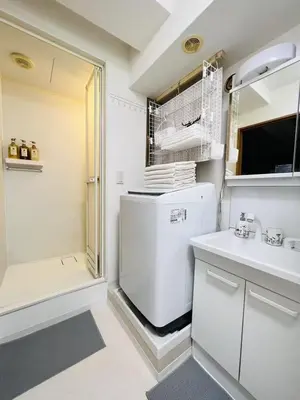 a white kitchen with a refrigerator and a sink at HAMAMATSUCHO Mansion #Minato-Ku in Tokyo