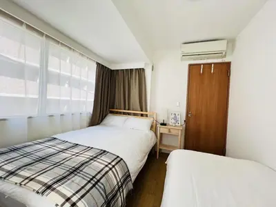 a hotel room with two beds and a window at HAMAMATSUCHO Mansion #Minato-Ku in Tokyo