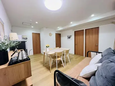 a living room with a table and a couch at HAMAMATSUCHO Mansion #Minato-Ku in Tokyo
