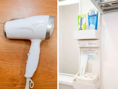 a white hair dryer is attached to a wall at Akihabara Skytree Premium Apartment 501 in Tokyo
