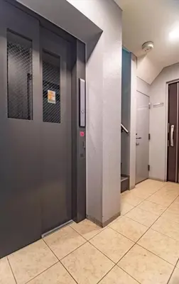 a hallway with two doors and a tile floor at Akihabara Skytree Premium Apartment 501 in Tokyo