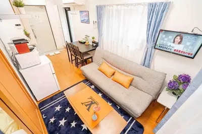 a living room with a couch and a table at Akihabara Skytree Premium Apartment 501 in Tokyo