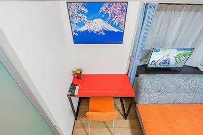 a small room with a red desk and a bed at My Sumida Home 2B in Tokyo