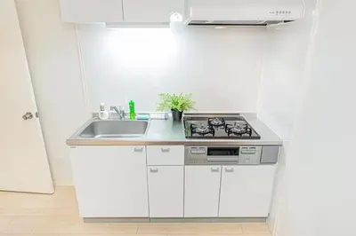 a white kitchen with a stove and a sink at My Sumida Home 2B in Tokyo