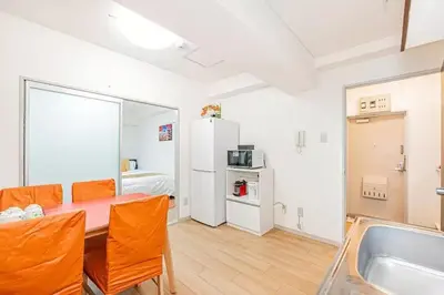 a room with a table and chairs and a kitchen at My Sumida Home 2B in Tokyo