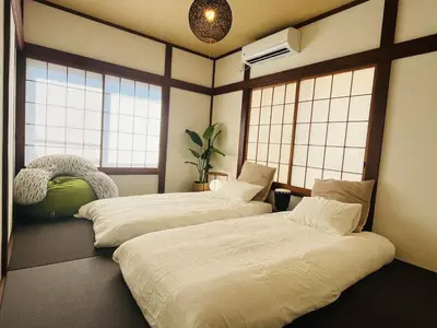 two beds in a room with windows at \u5fb9\u6c5f\u6238\u5ddd in Tokyo