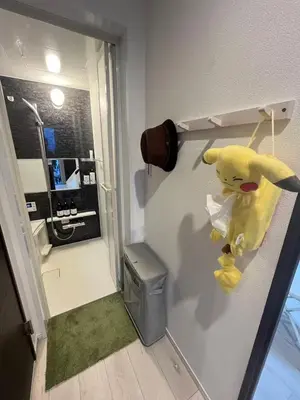 a stuffed animal is hanging on a wall in a room at \u5fb9\u6c5f\u6238\u5ddd in Tokyo