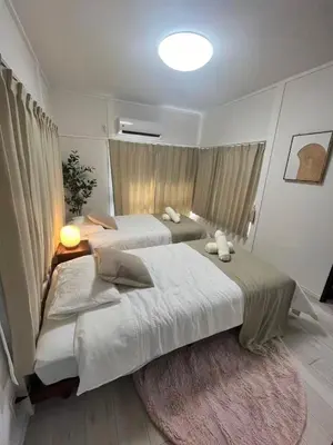 a bedroom with two beds and a rug at \u5fb9\u6c5f\u6238\u5ddd in Tokyo