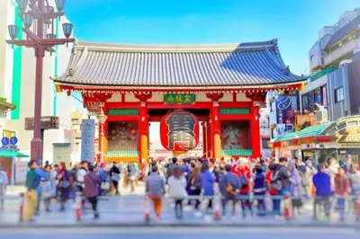 a crowd of people walking in front of a temple at Tokiwa INN in Tokyo