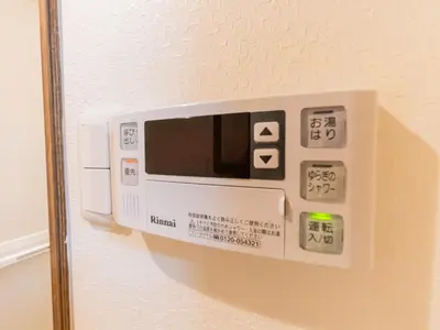 a microwave hanging on the wall of a room at Tokiwa INN in Tokyo