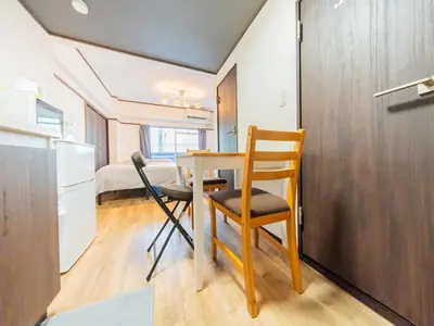 a kitchen with a table and chairs in a room at Tokiwa INN in Tokyo