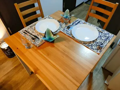 a wooden table with two white plates on it at Tokiwa INN in Tokyo