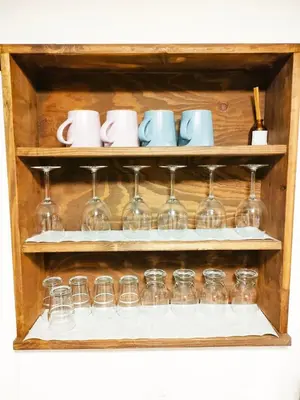 a set of wine glasses and cups on a shelf at Tokiwa INN in Tokyo