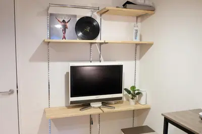 a television sitting on a wooden shelf in a room at Horizon Bleu Asakusa Room 102 - Vacation STAY 01888v in Tokyo