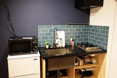 a small kitchen with a sink and a microwave at Horizon Bleu Asakusa Room 102 - Vacation STAY 01888v in Tokyo