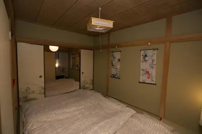 a bedroom with a bed and a ceiling fan at Shinagawa-ku - House - Vacation STAY 19990 in Tokyo