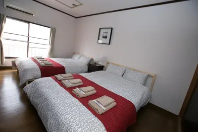 two beds sitting next to each other in a bedroom at Shinagawa-ku - House - Vacation STAY 19990 in Tokyo