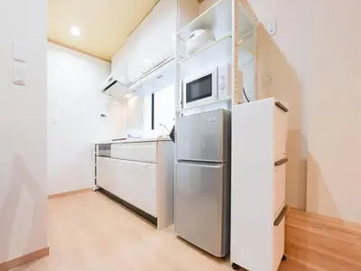 a kitchen with a refrigerator and a microwave at Sumida-ku - Apartment - Vacation STAY 19991 in Tokyo