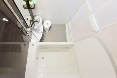 a bathroom with a sink and a toilet paper dispenser at Sumida-ku - Apartment - Vacation STAY 19991 in Tokyo