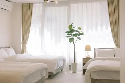 a bedroom with two beds and a large window at 8min walk from Shibuya Sta Universal design in Tokyo