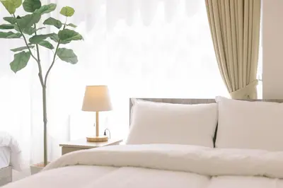 a bedroom with a white bed and a plant at 8min walk from Shibuya Sta Universal design in Tokyo