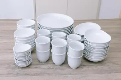 a stack of white plates sitting on top of a table at 8min walk from Shibuya Sta Universal design in Tokyo